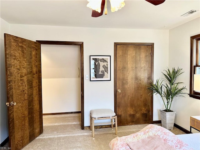 bedroom with ceiling fan and light carpet