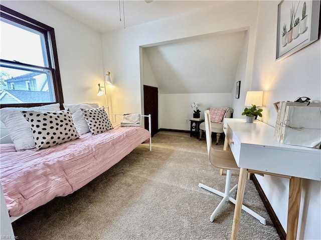 carpeted home office featuring vaulted ceiling