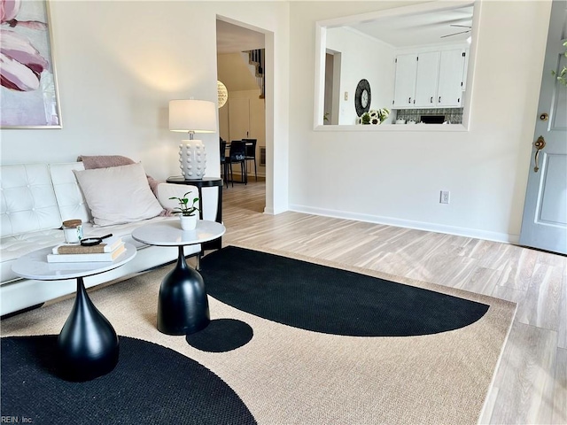 living area featuring ceiling fan and light hardwood / wood-style floors