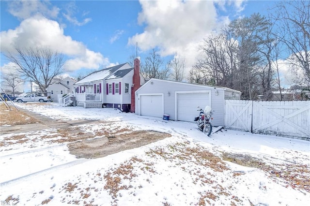 view of front of property with an outbuilding, a garage, and a deck