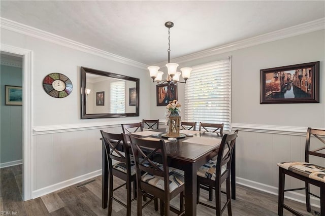 dining area with a notable chandelier, dark hardwood / wood-style flooring, and crown molding