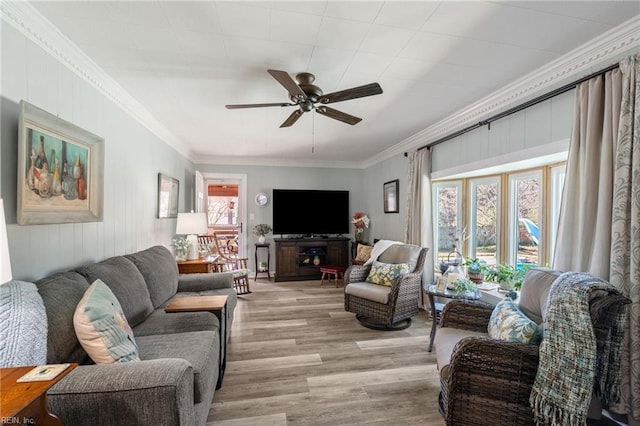 living room featuring a healthy amount of sunlight, ornamental molding, and light hardwood / wood-style floors