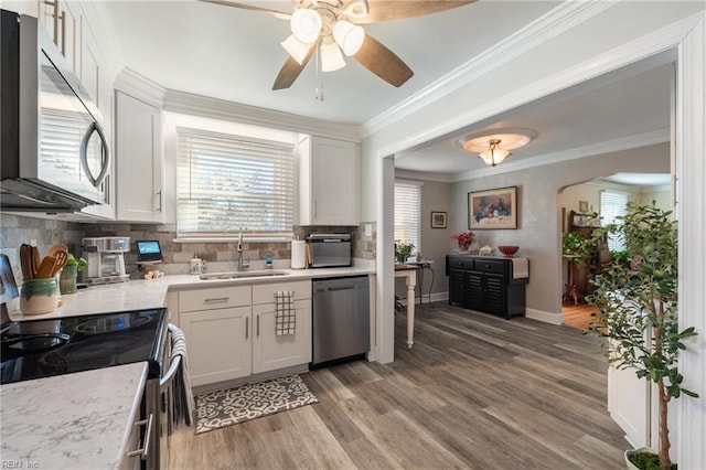 kitchen featuring sink, white cabinetry, stainless steel appliances, and tasteful backsplash