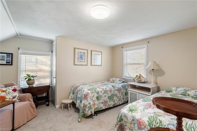 bedroom with light carpet, multiple windows, and lofted ceiling