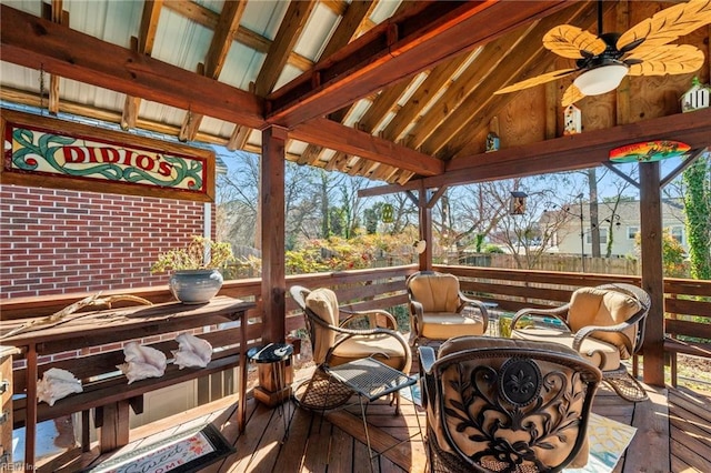 wooden terrace featuring ceiling fan and a gazebo