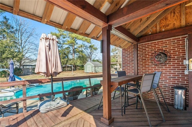 wooden terrace featuring a storage shed