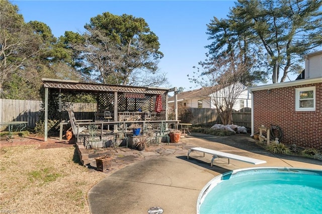 view of swimming pool with a patio area, a gazebo, and a diving board