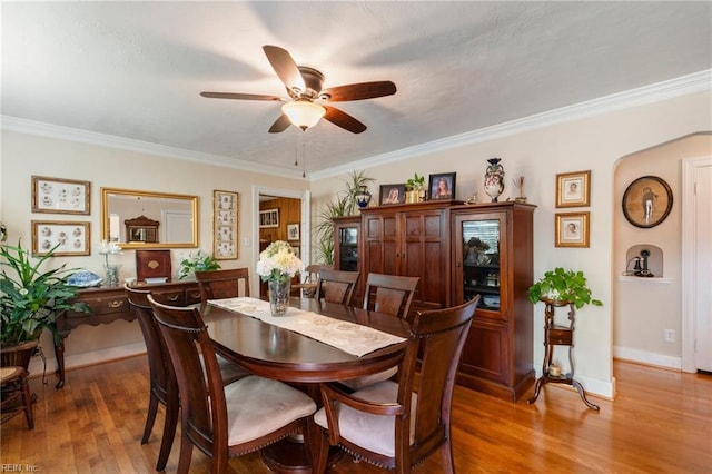 dining room featuring ceiling fan, ornamental molding, and hardwood / wood-style floors