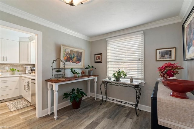 interior space with ornamental molding and wood-type flooring