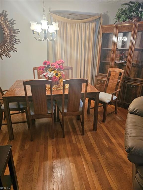 dining area featuring an inviting chandelier and hardwood / wood-style floors