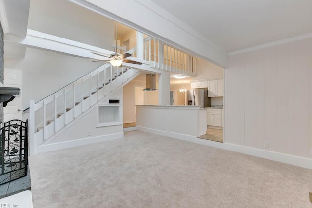 unfurnished living room featuring ceiling fan, light colored carpet, and crown molding