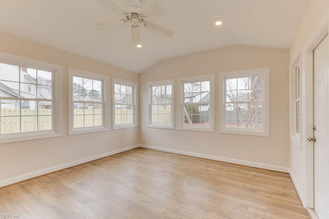 unfurnished sunroom with ceiling fan and vaulted ceiling