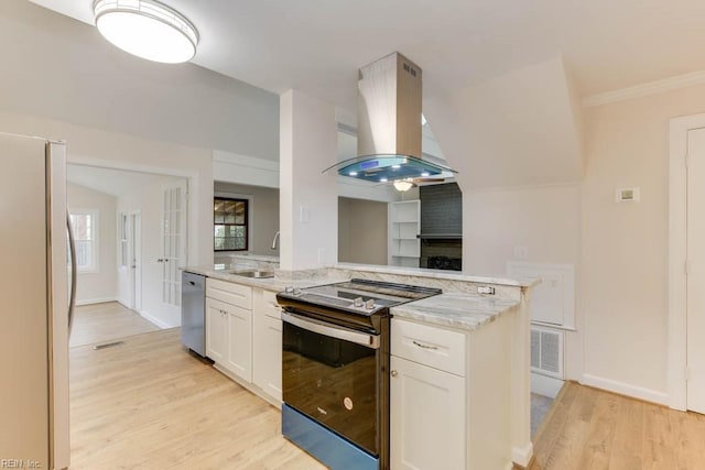 kitchen featuring kitchen peninsula, white cabinetry, stainless steel appliances, island range hood, and light stone counters