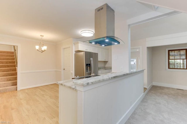 kitchen with pendant lighting, white cabinets, stainless steel refrigerator with ice dispenser, kitchen peninsula, and island range hood