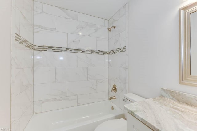 full bathroom featuring toilet, tiled shower / bath combo, and vanity