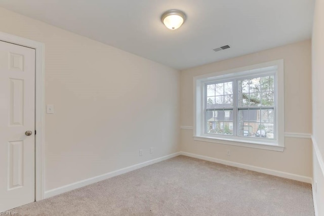 unfurnished room with light carpet