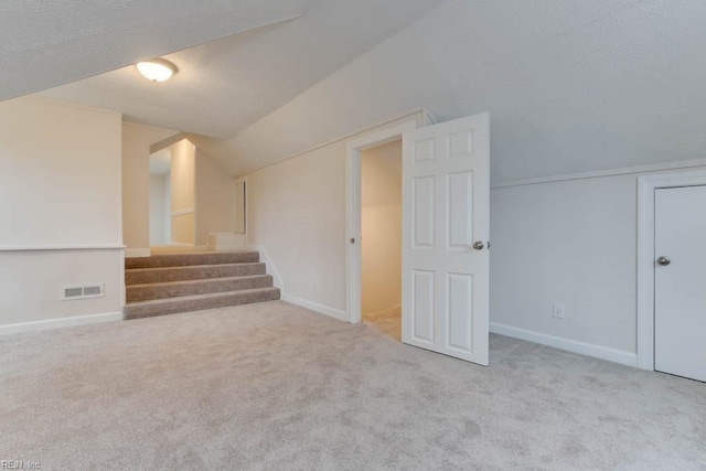 interior space with light colored carpet and a textured ceiling