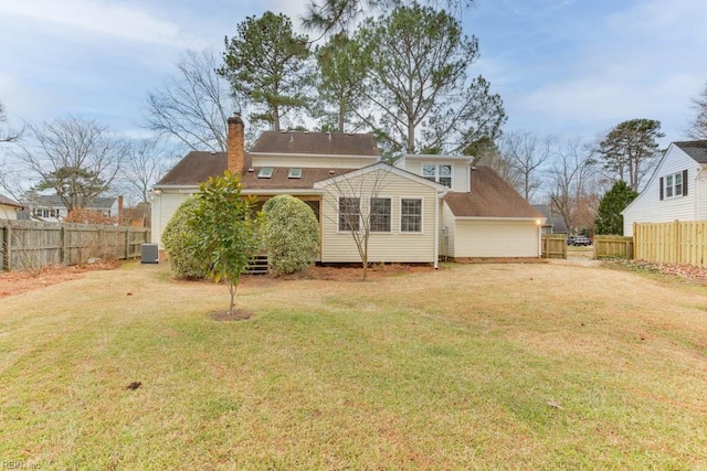 rear view of property featuring cooling unit and a lawn