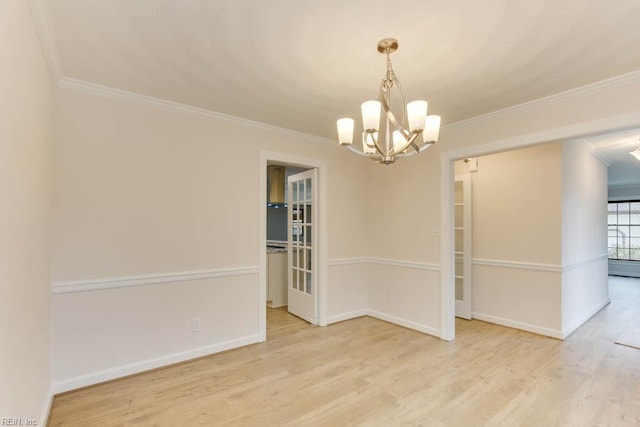 empty room with light hardwood / wood-style floors, crown molding, and a notable chandelier