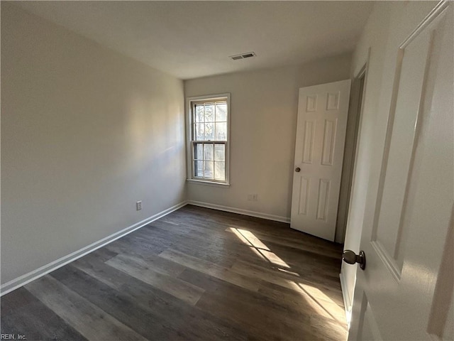 unfurnished room featuring dark hardwood / wood-style floors