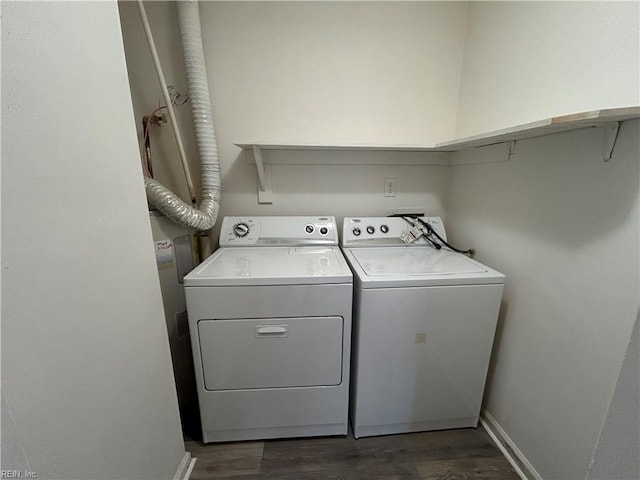 clothes washing area featuring dark wood-type flooring and independent washer and dryer