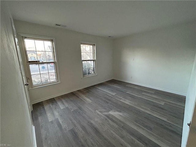 unfurnished room featuring dark hardwood / wood-style flooring