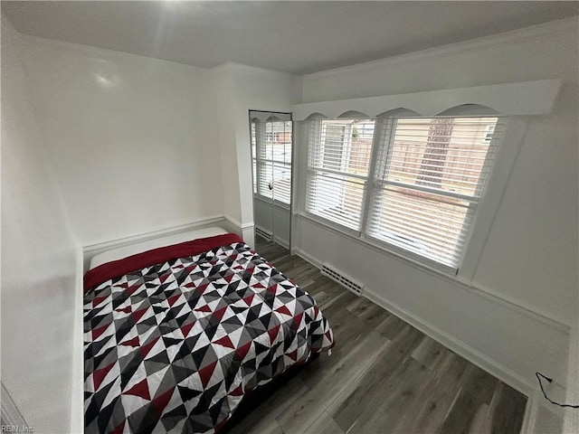 bedroom with dark hardwood / wood-style floors