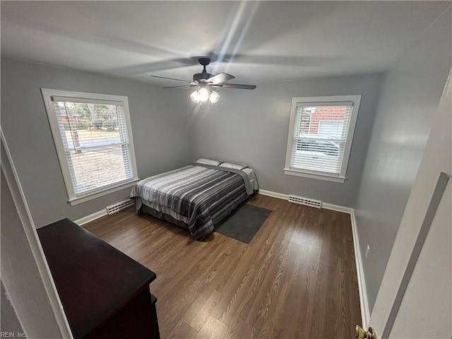 bedroom with ceiling fan and dark hardwood / wood-style flooring