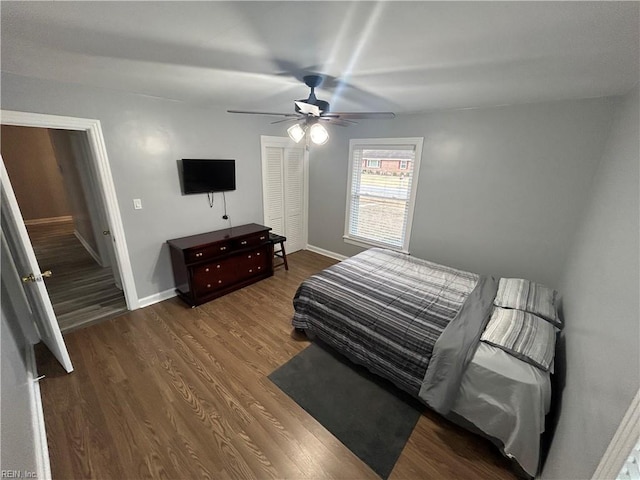 bedroom with ceiling fan and dark hardwood / wood-style floors