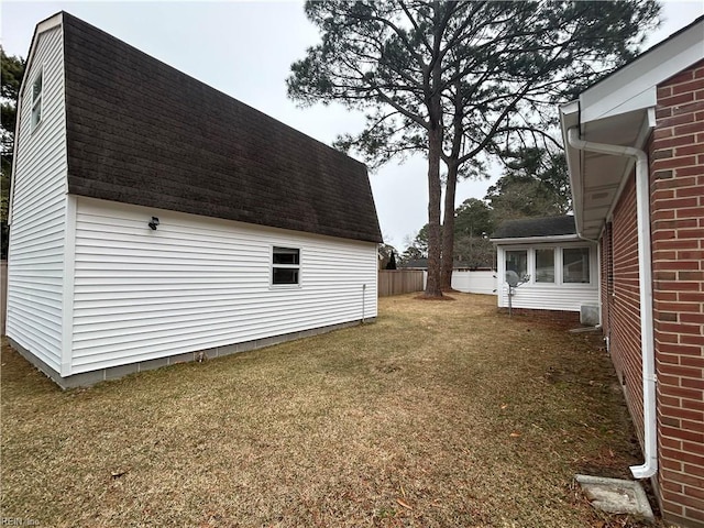 view of side of property with a yard