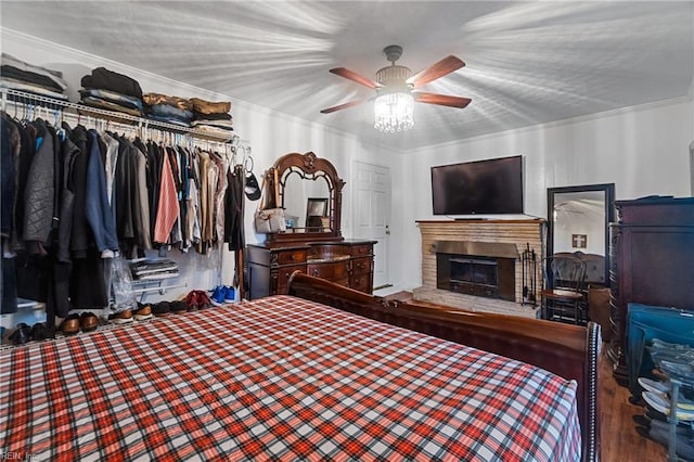 bedroom with ceiling fan, wood-type flooring, a closet, and crown molding