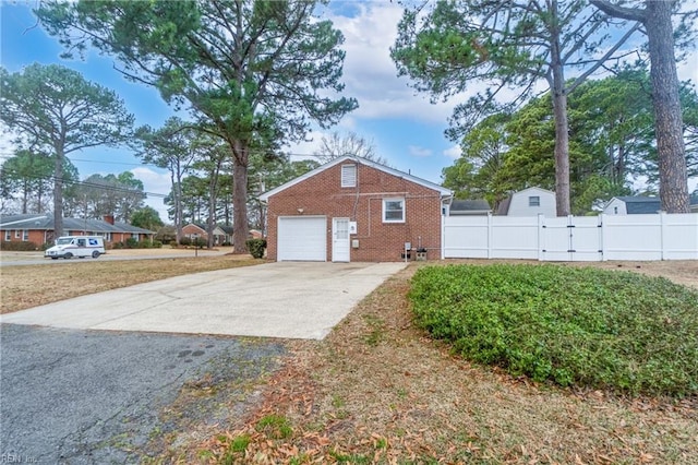 view of side of property featuring a garage and a yard