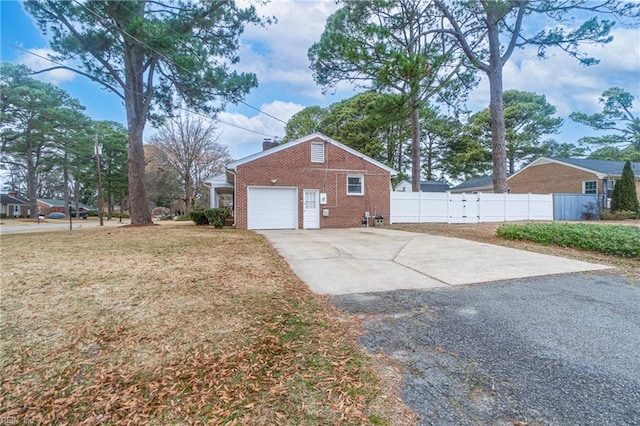 view of side of home with a garage and a yard