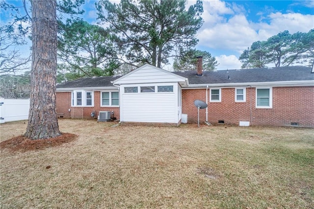 rear view of house with a yard and central AC