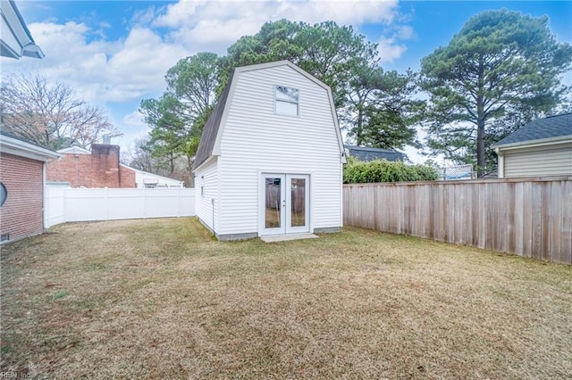 back of house featuring french doors and a yard