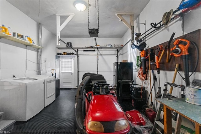 garage with washing machine and dryer, a garage door opener, and black fridge