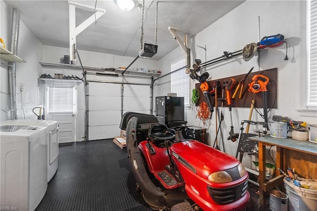 garage featuring independent washer and dryer and a garage door opener