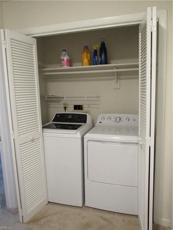 laundry area with light carpet and washer and dryer