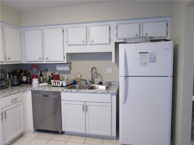 kitchen with white refrigerator, dishwasher, white cabinetry, and sink