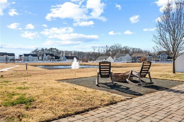 exterior space with a water view and a lawn