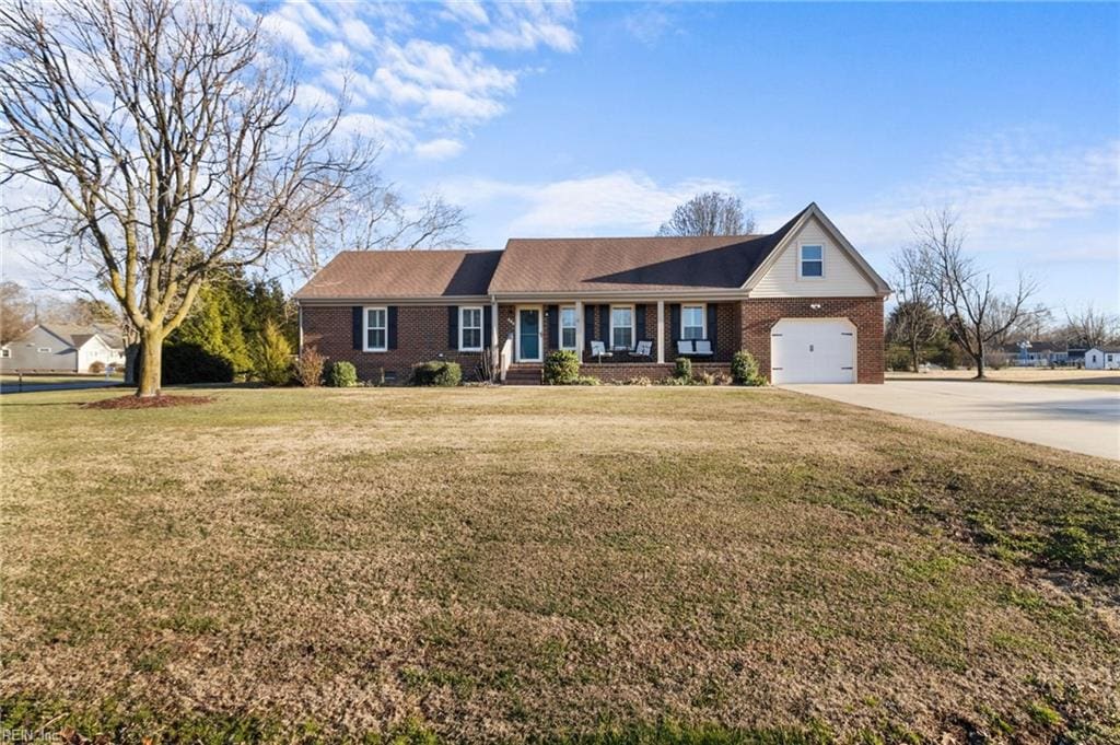 ranch-style home with a front lawn and a garage