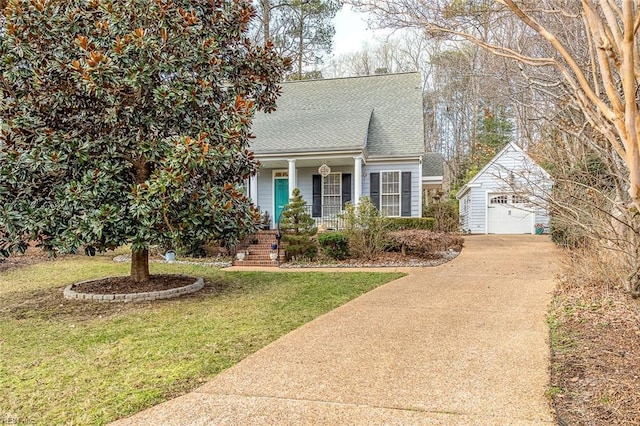 view of front facade featuring an outbuilding, a garage, a front yard, and covered porch