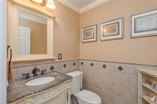 bathroom featuring ornamental molding, toilet, tile walls, and vanity