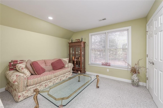 carpeted living room with vaulted ceiling