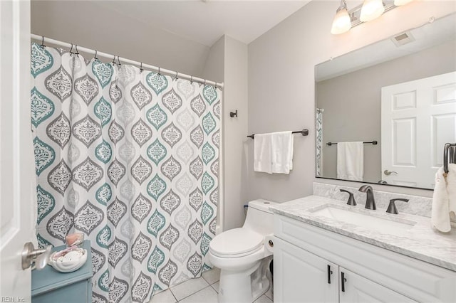 bathroom featuring vanity, tile patterned floors, and toilet