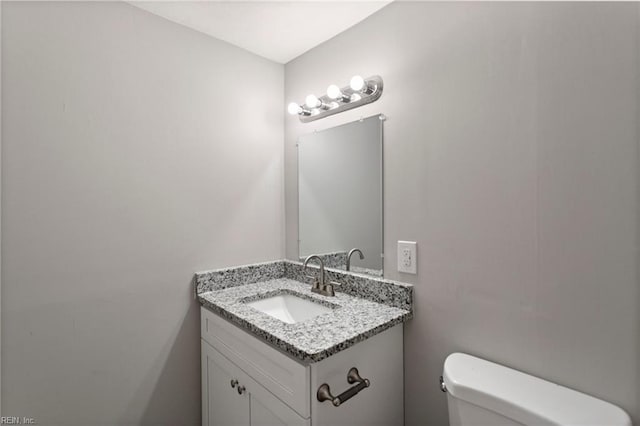 bathroom featuring toilet and vanity