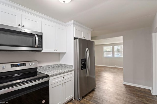 kitchen featuring light stone countertops, appliances with stainless steel finishes, dark hardwood / wood-style flooring, and white cabinetry