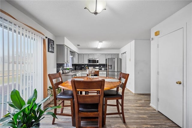 dining space featuring dark hardwood / wood-style flooring and sink