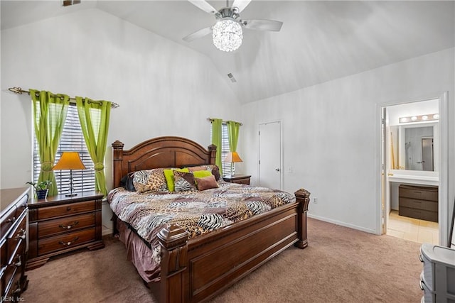 bedroom featuring light carpet, ceiling fan, lofted ceiling, and ensuite bath