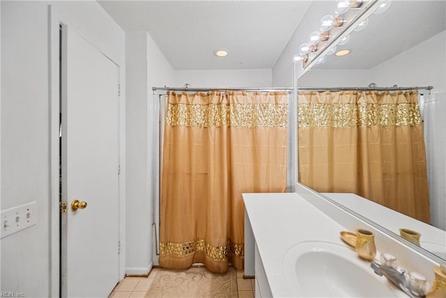 bathroom featuring curtained shower, tile patterned floors, and vanity